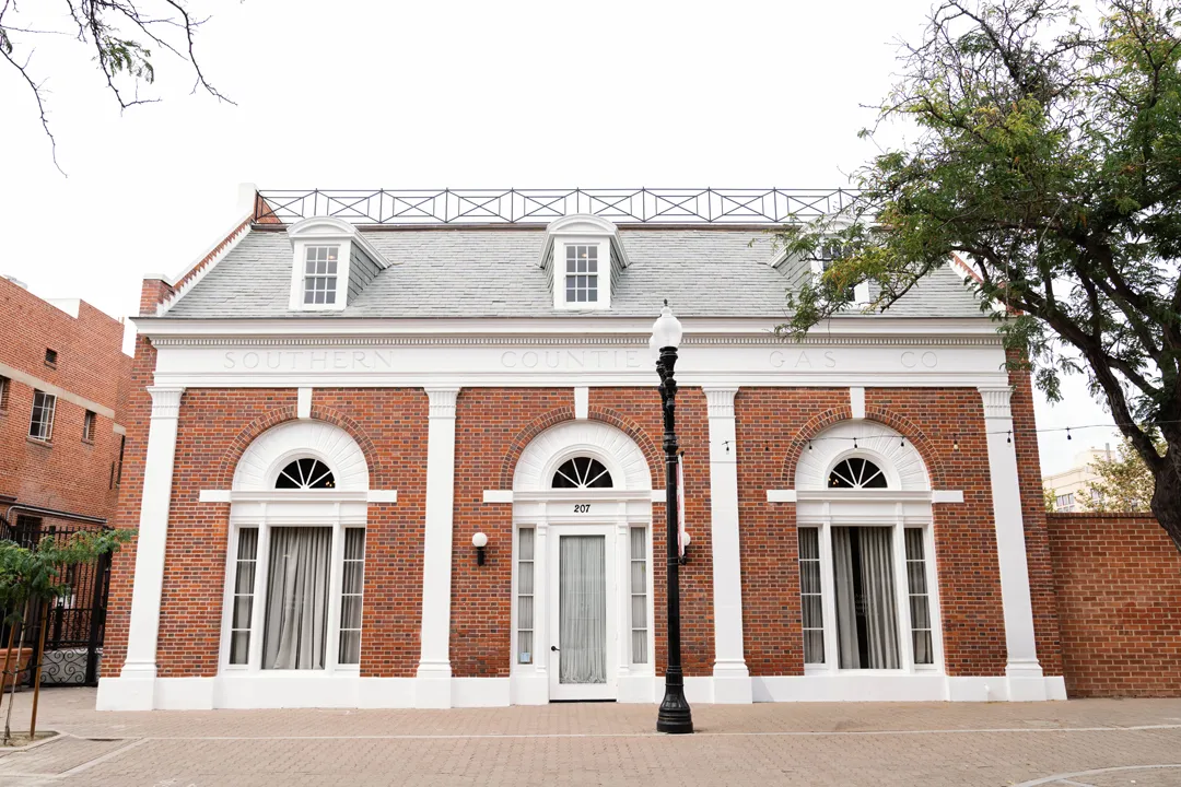 Red brick and white-trimmed facade of the Estate on Second.