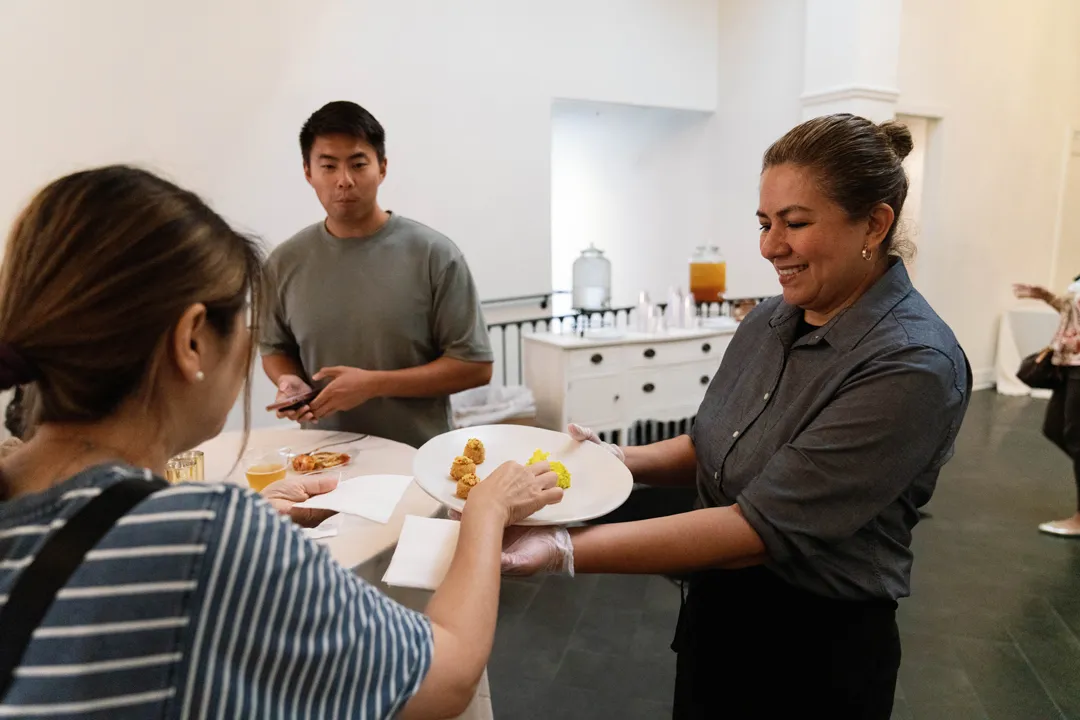 Jay's Catering server offering appetizers to tasting guests at The Estate on Second.