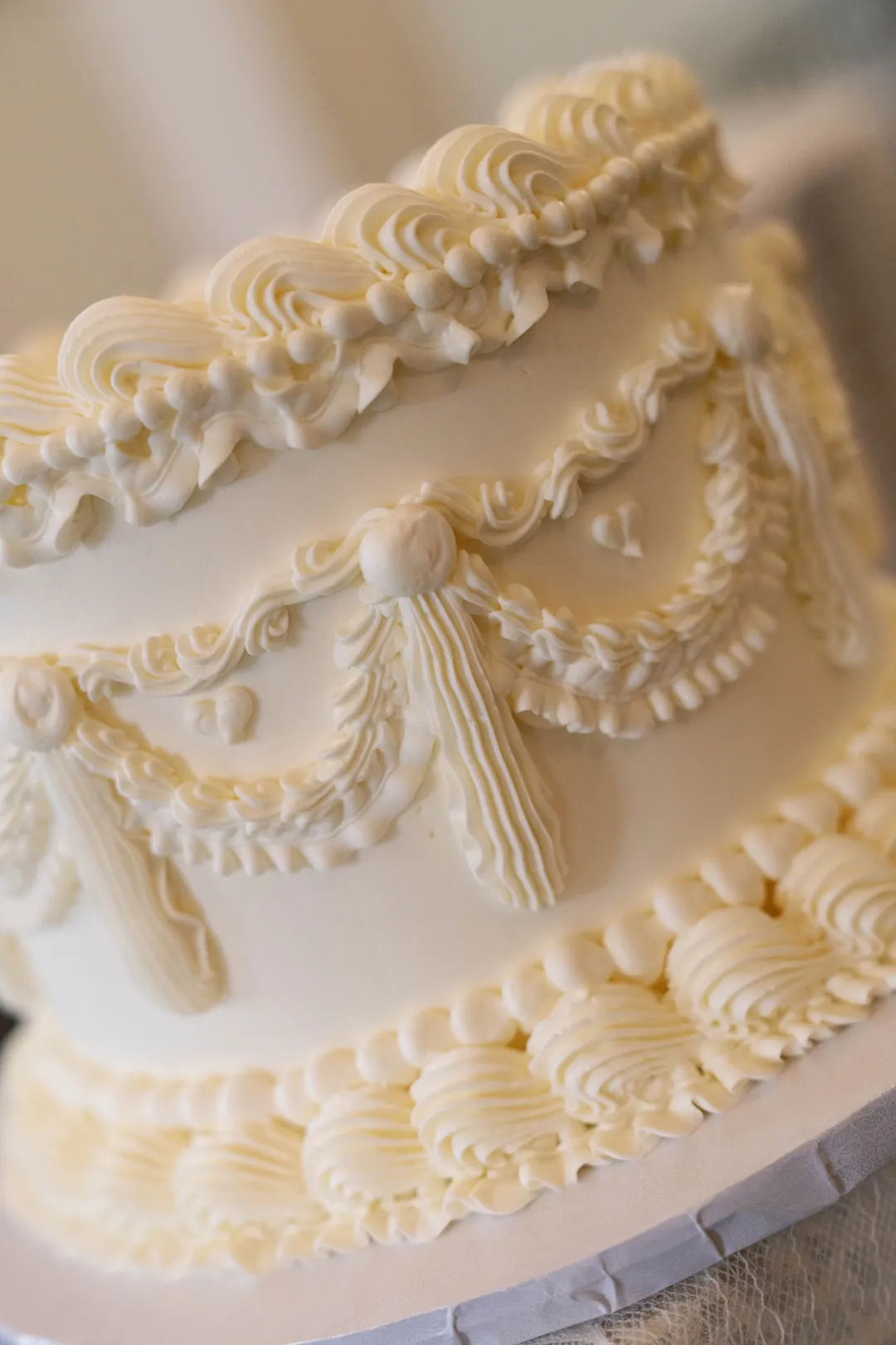 Jay's Catering white cake with piped frosting swags and borders.