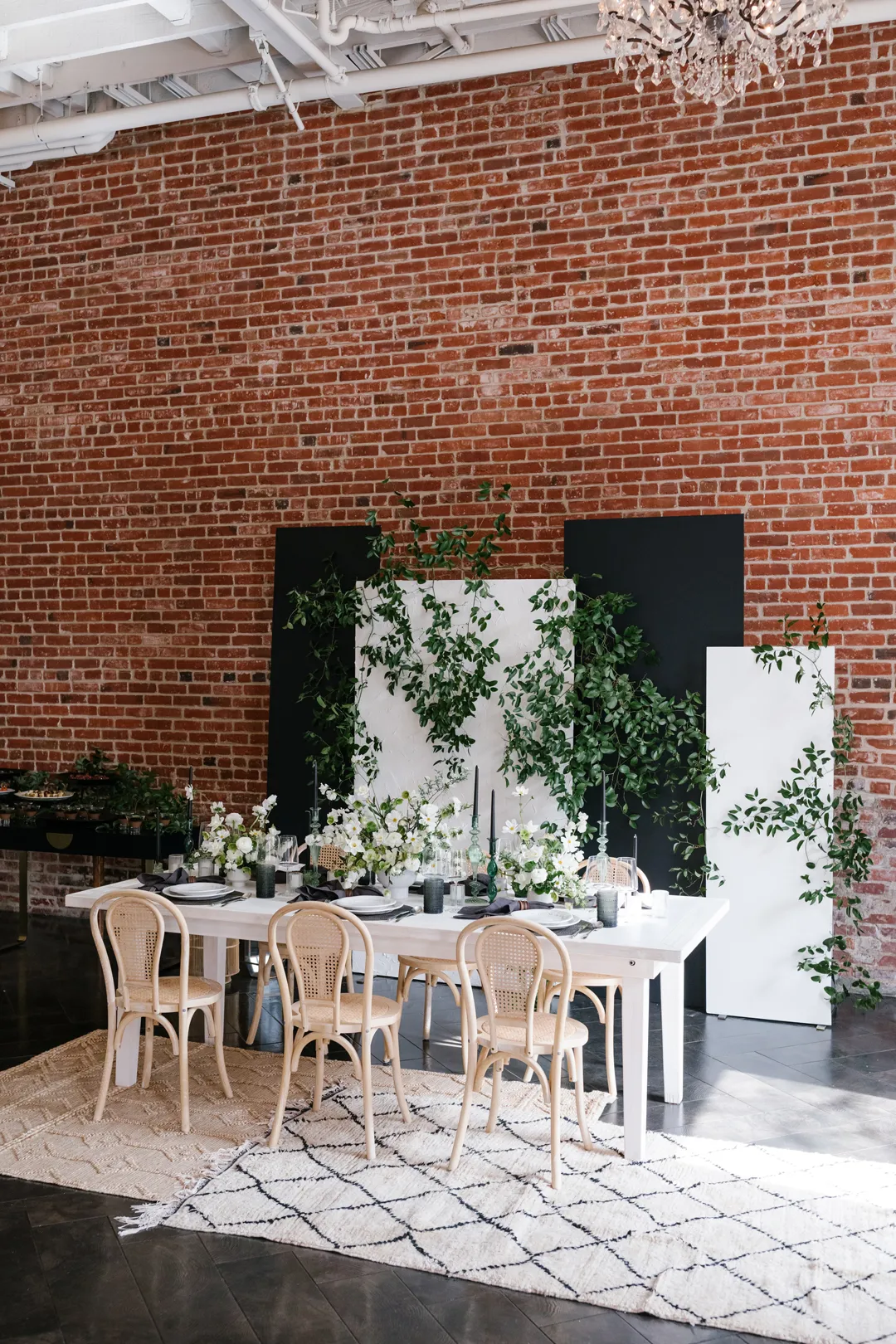 Intimate dining setup with white flowers and greenery at The Estate on Second.