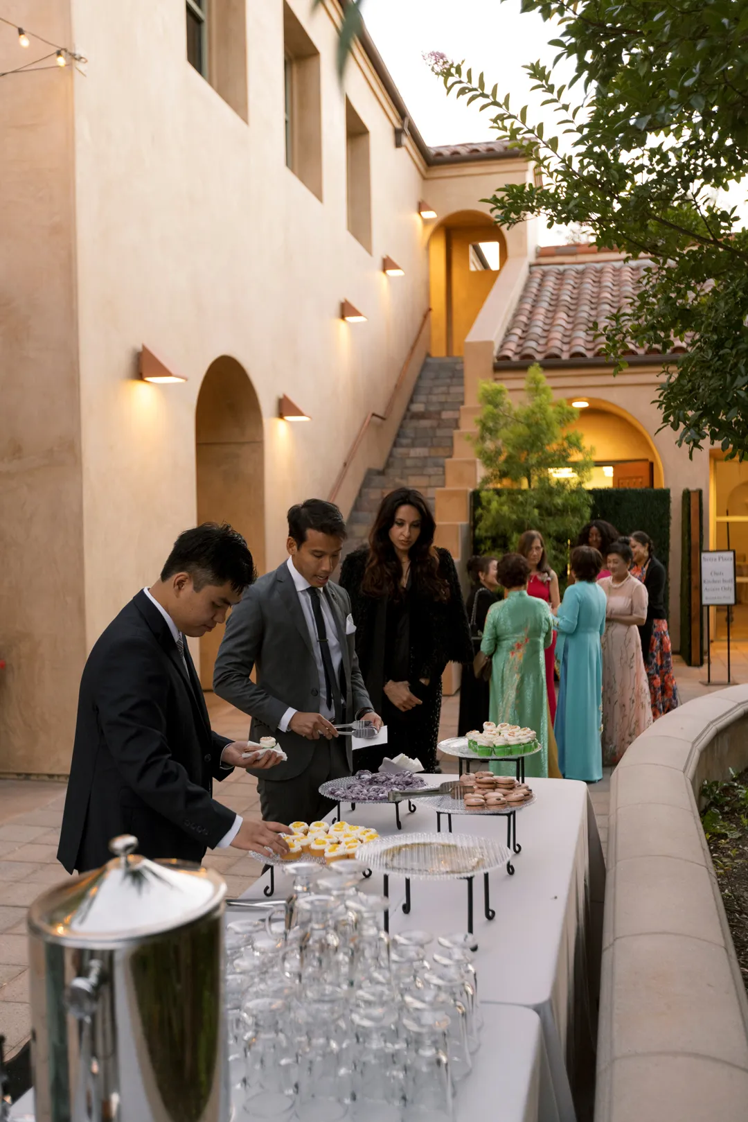 Wedding guests choosing miniature desserts at the Jay's Catering dessert station.
