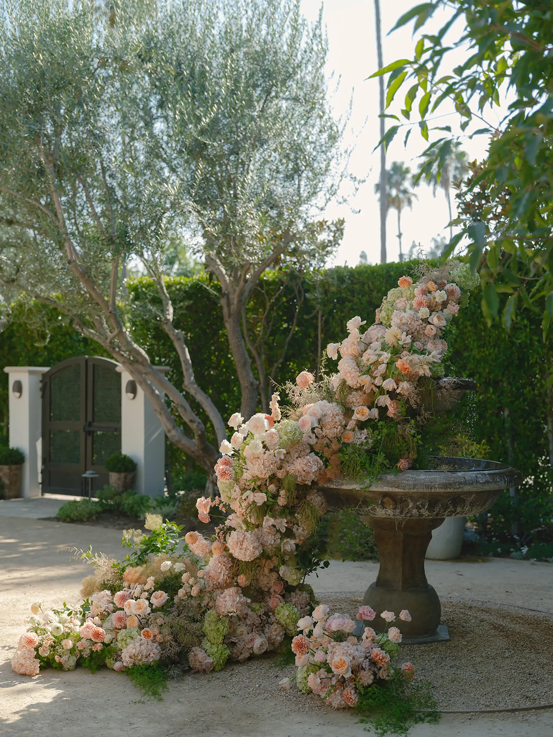 Romantic florals in blush pink decorate the original fountain at Grand Gimeno.