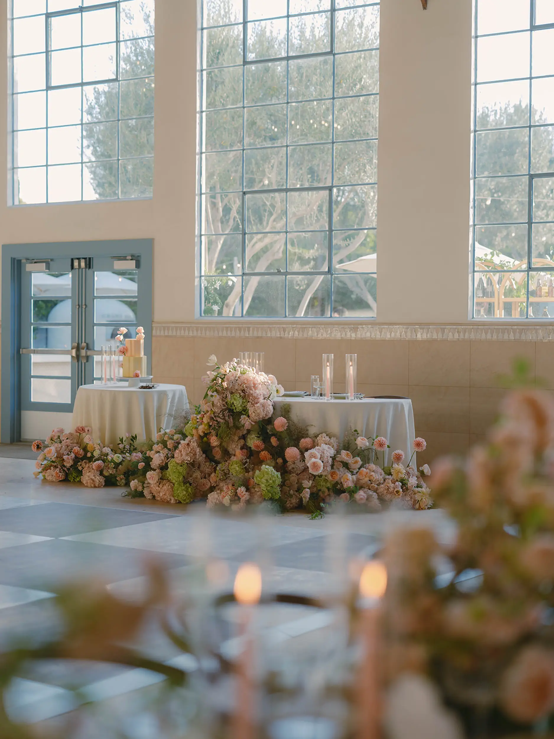 Inside Grand Gimeno the wedding sweetheart table is decorated with romantic, overgrown tulips, dahlias, Juliet roses, and more. 