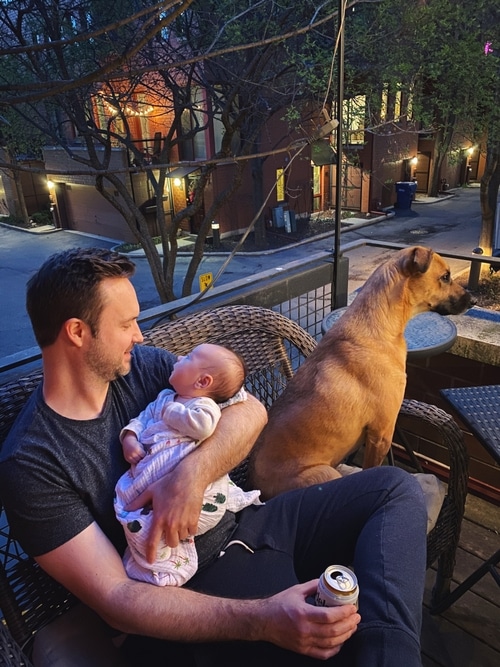 Dan, Nico and Kona sitting outside