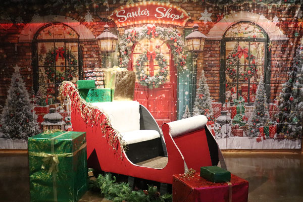 Photo Op for Holiday Lights with Santa Sleigh and festive backdrop