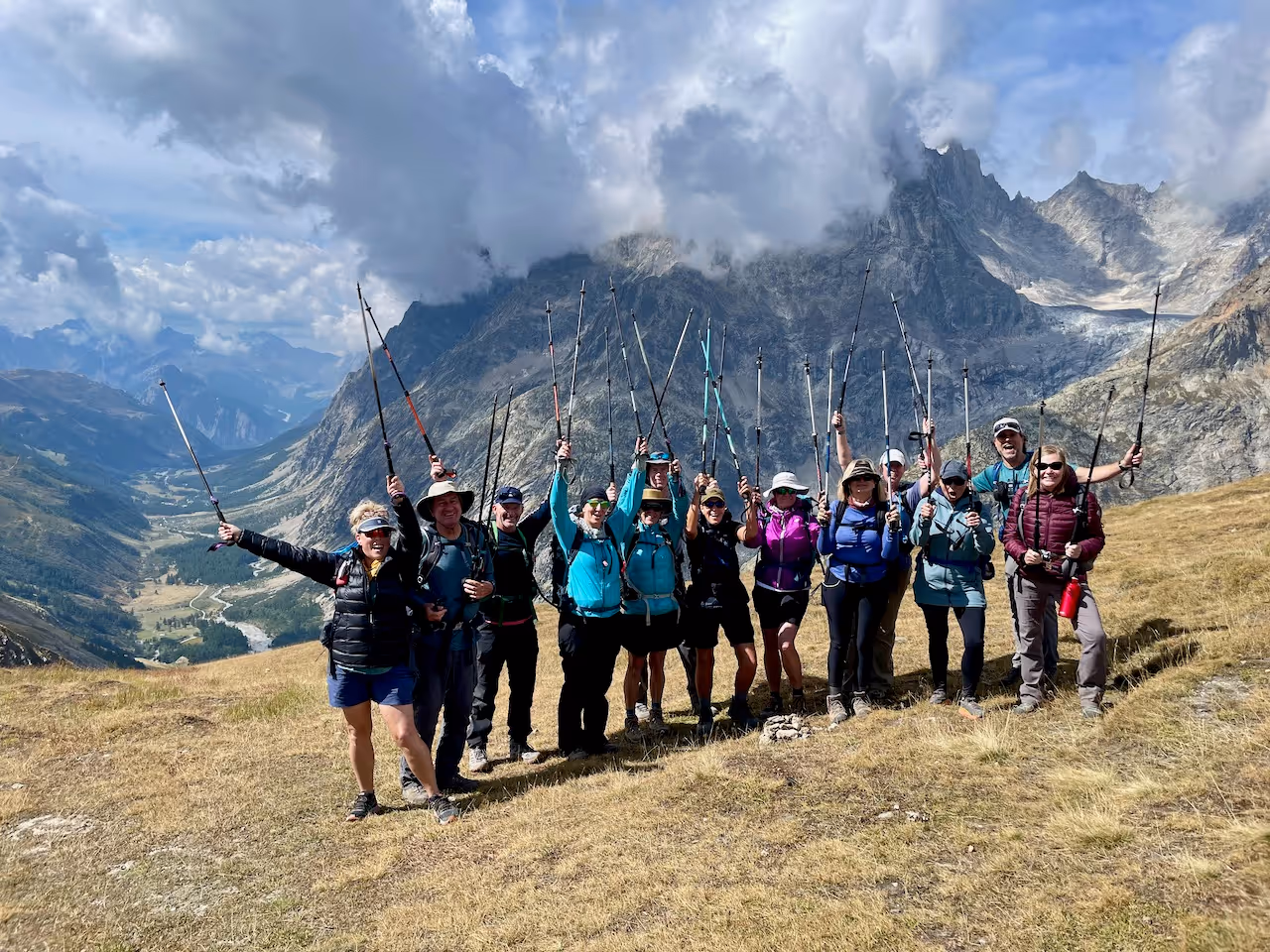 Hikers using trekking poles on a mountain trail