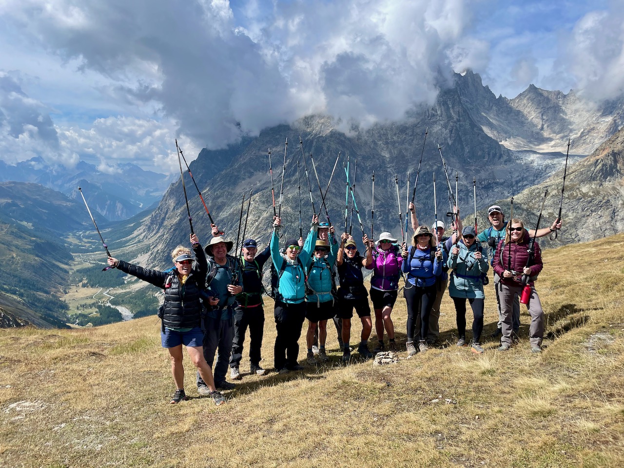 Hikers using trekking poles on a mountain trail