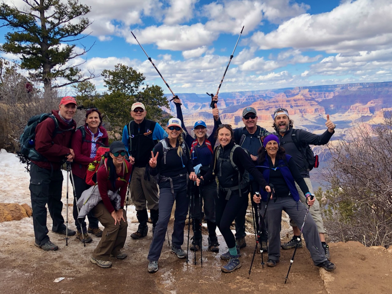 Hiker with trekking poles on a scenic mountain trail