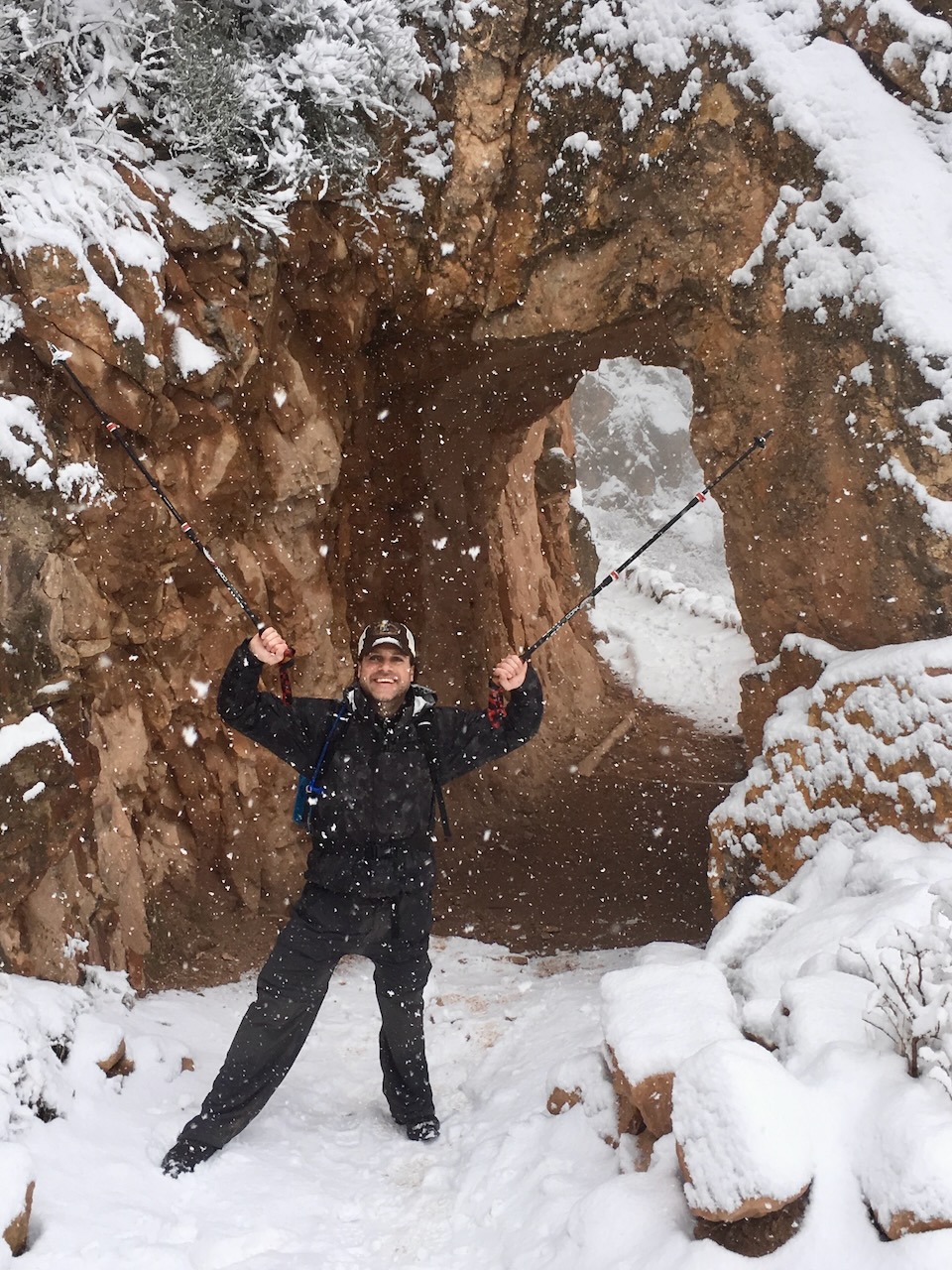 Hikers with trekking poles in snowy Grand Canyon conditions