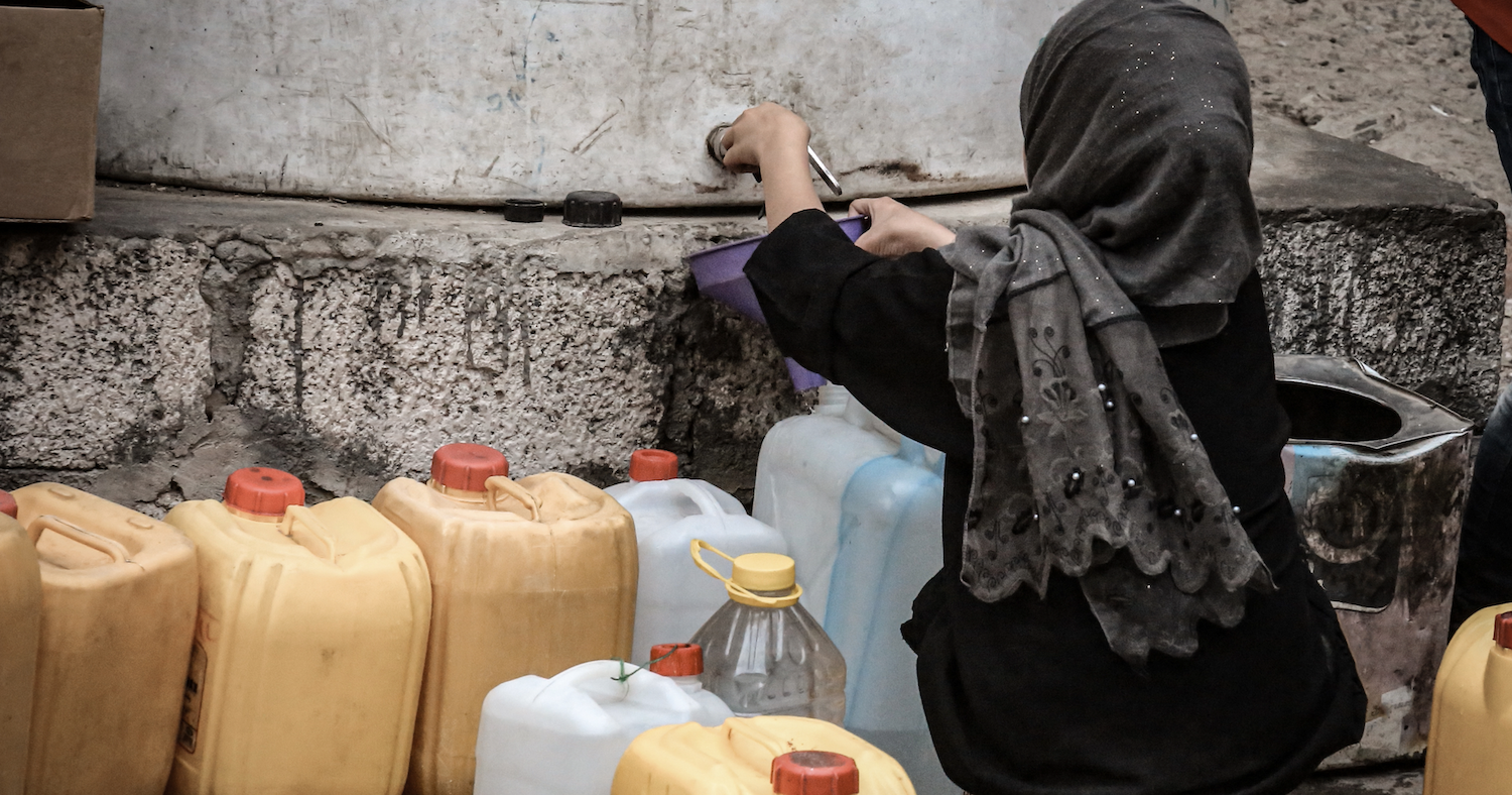 A girl fetches water during a water crisis in Taiz, Yemen. Photo by Akram Alrasny via Adobe Stock, used under the Standard license.