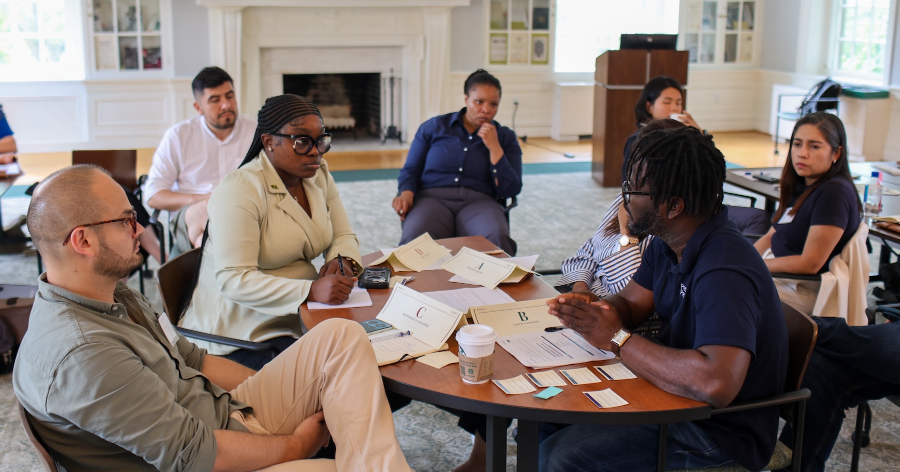 Global Democracy Fellows, led by AidData Training and Instructional Design Manager Sethu Nguna, engage in negotiations during the development of a joint statement. Photo by the Presidential Precinct, used with permission.