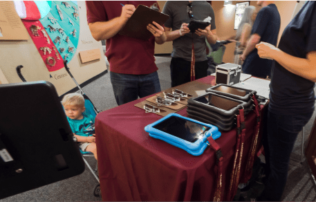 Usability Testing at the Arizona Museum of Natural History. Control and Game Mode versions of the app are set up on color coded iPads on a welcome table for guests to take.