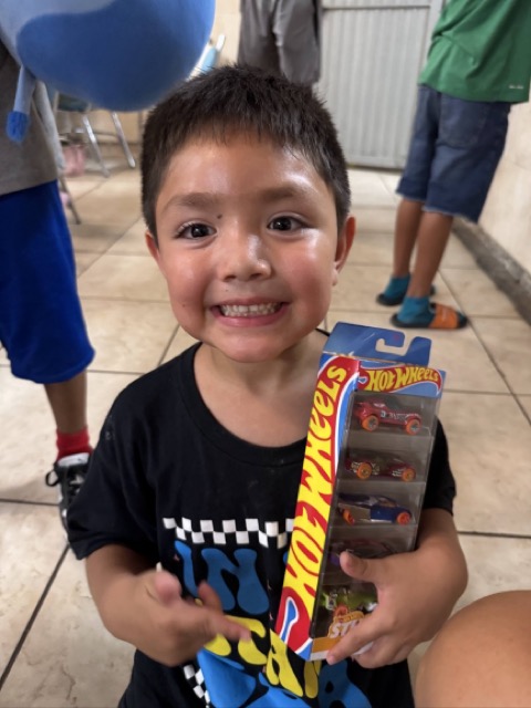 Smiling child holding a toy