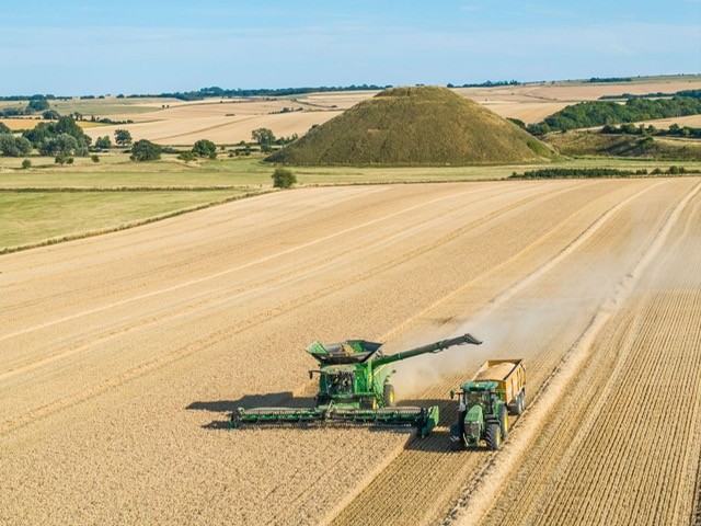 The Property Hounds image of a combine bringing in the harvest at Silsbury Hill
