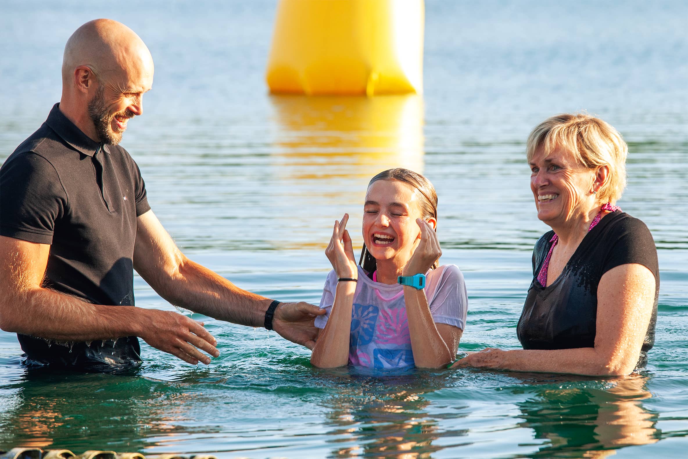 Girl being baptised in a lake at regeneration Church