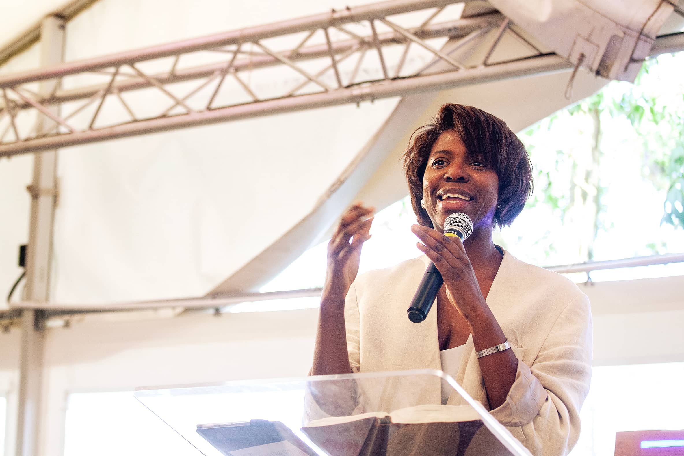 Preacher giving a message in front of a perspex lecturn