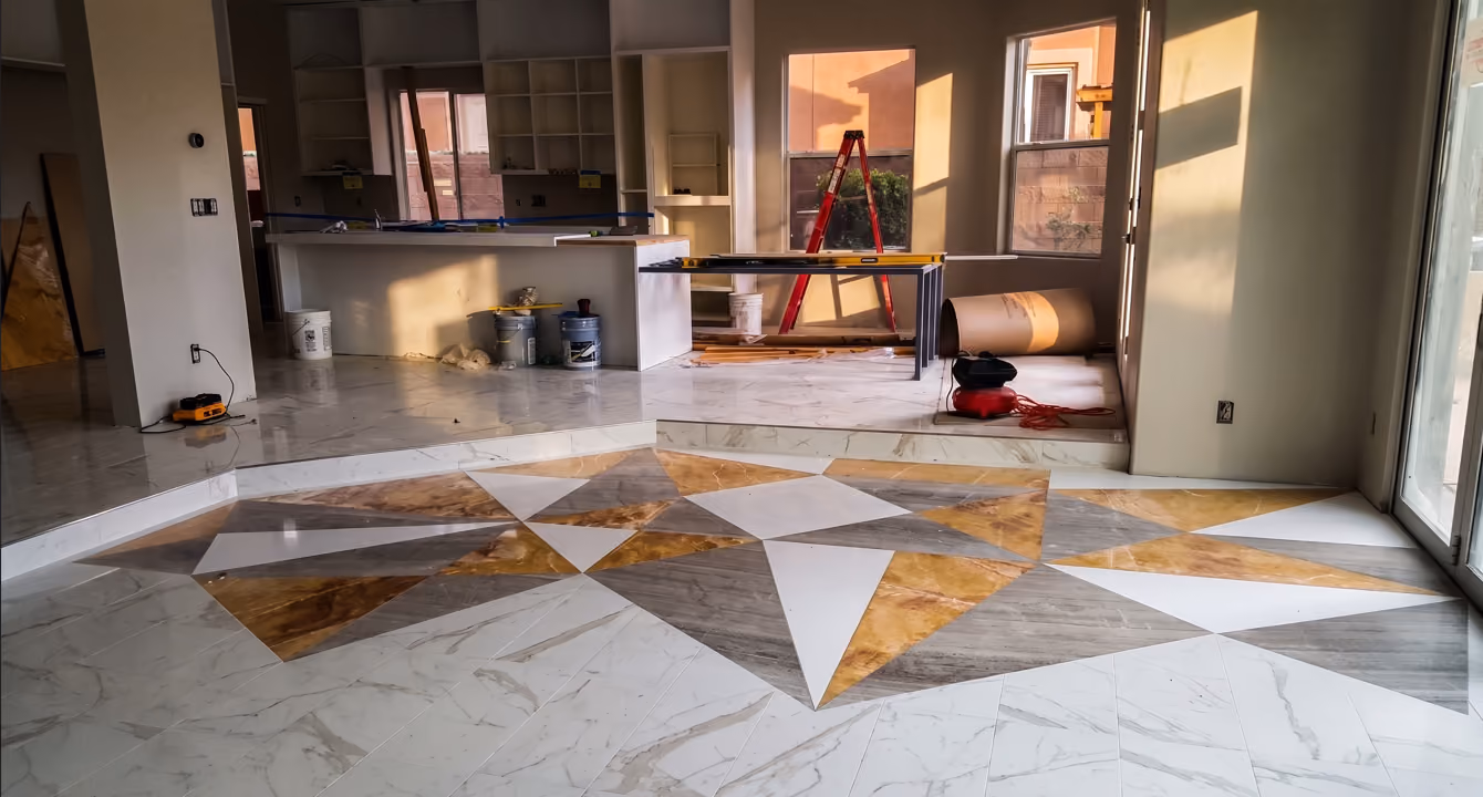 Full-gut residential renovation in Eagle Hills, Las Vegas, creating a modern home for entertaining with custom geometric stone flooring, kitchen cabinetry, and new interior finishes