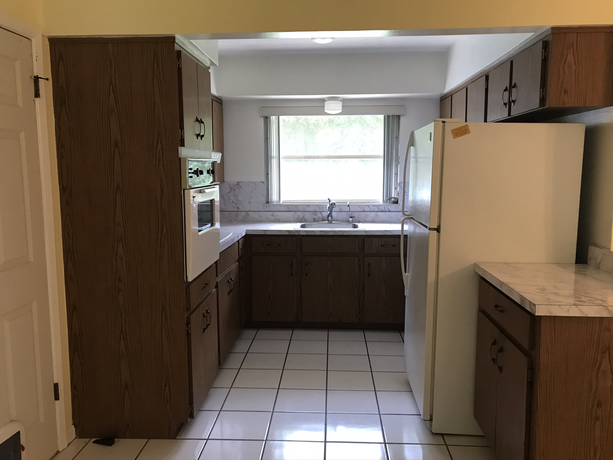 Kitchen with fridge and built in oven