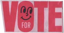 a paper cutout with the word "VOTE" in red, with a smiley face inside the letter o