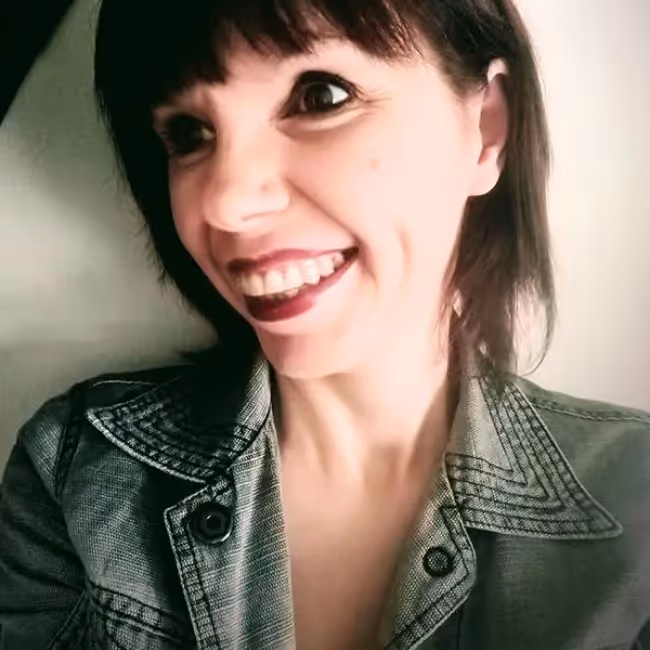 patrizia bertini headshot - woman with short dark hair in a denim shirt