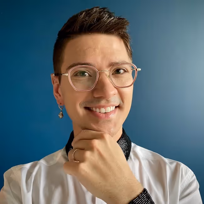 ux research yearbook devin harold headshot - man with short hair wearing clear glasses and putting hand on chin