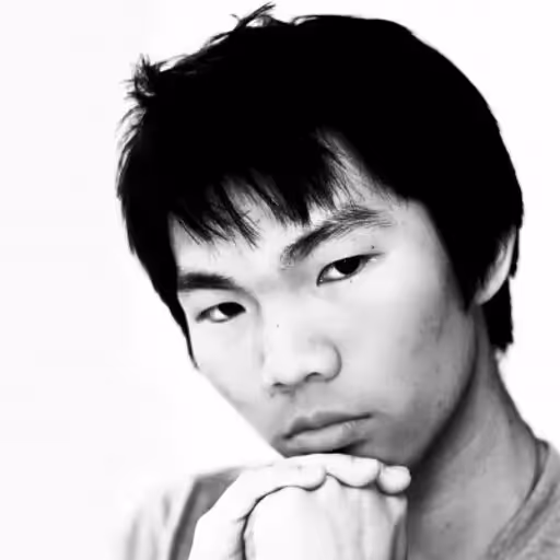 black and white headshot for sherwin yu, a man with dark hair who is crossing their hands under their chin while looking at the camera