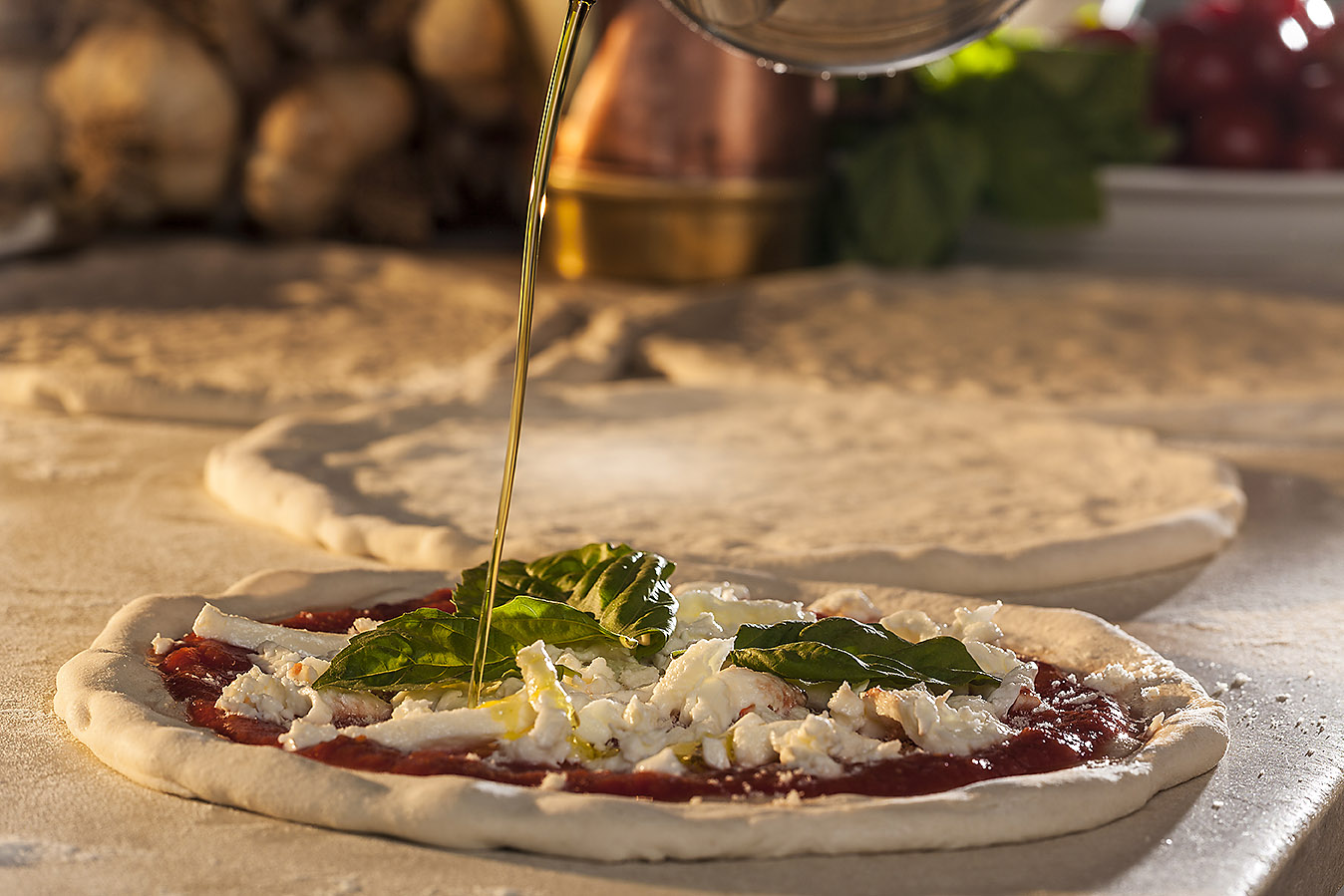 Pizza Picchio pizza being prepared with olive oil