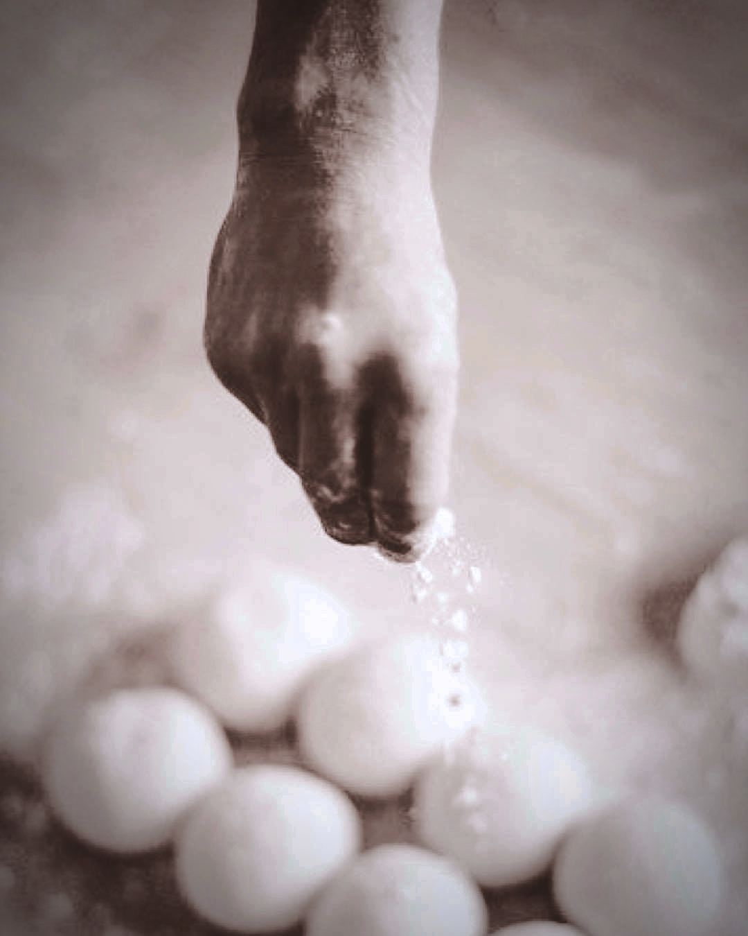 Pizza dough being worked by hand