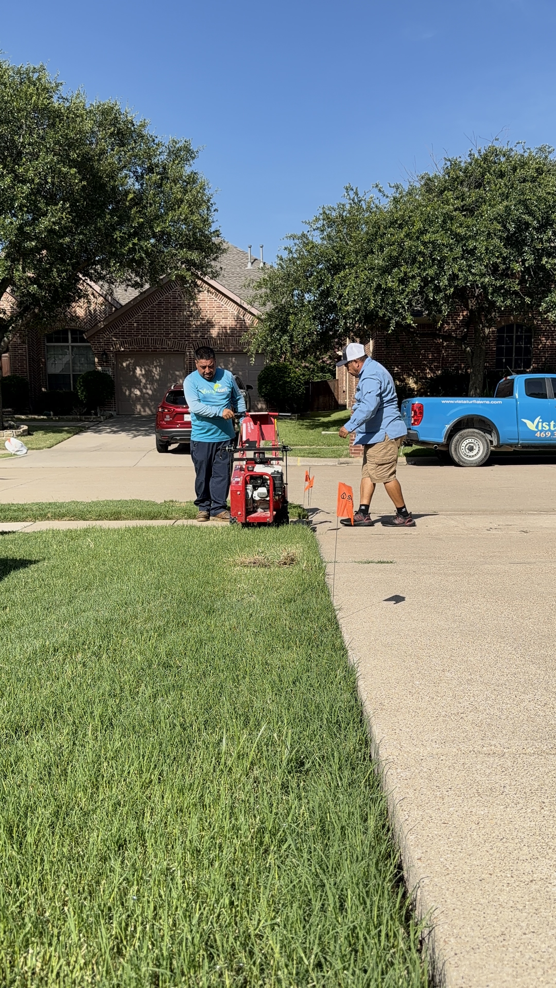 Vista Lawn and Pest crew performing lawn edging and maintenance at a residential property in DFW