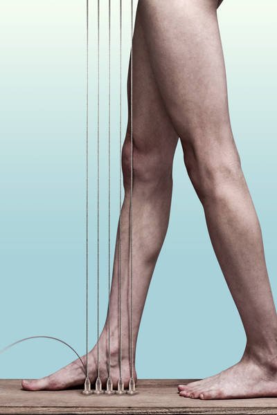 Low Section Of Man Standing By Strings Against Wall