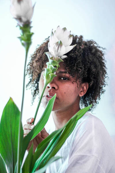 Close-Up Portrait Of Young Woman By White Flowers