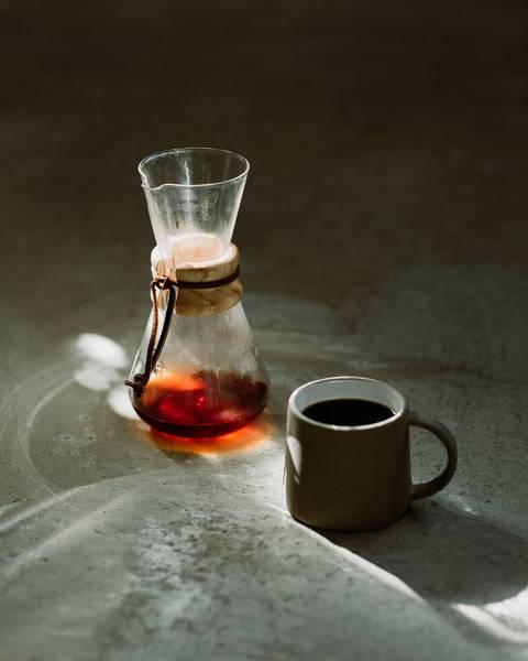 Close-Up Of Coffee Cup And Container On Table