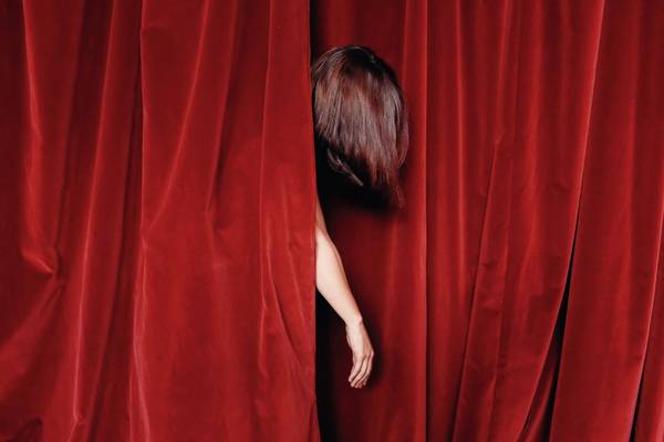 Cropped Image Of Woman Amidst Stage Curtain