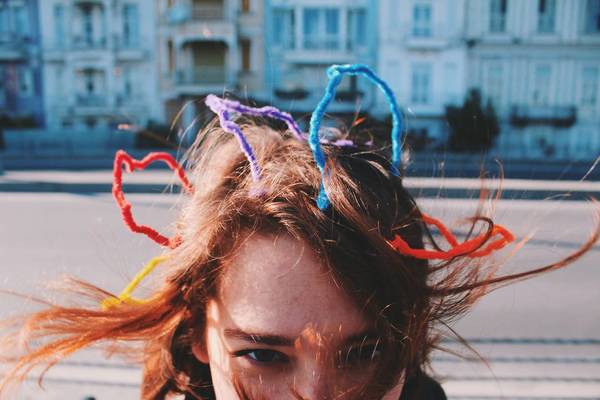 Close-Up Portrait Of Woman Wearing Headdress Against Buildings