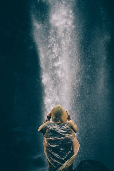 Rear View Of Woman Looking At Waterfall