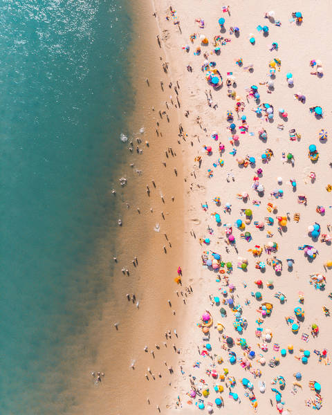 Drone Shot Of Colorful Parasols And People At Beach During Summer