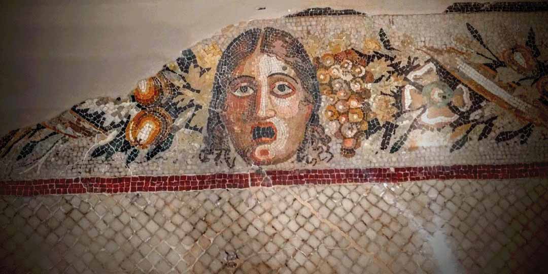Face in mosaics at Domvs Romana