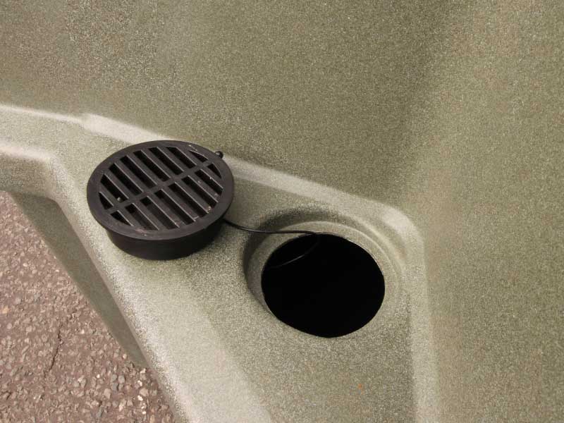 Removable, tethered urinal drain for emptying