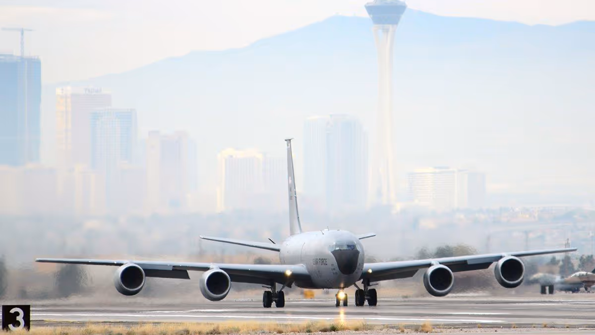 U.S. Air Force tanker aircraft taxiing on Nellis Air force Baserunway with Las Vegas cityscape and Stratosphere Tower in the background.