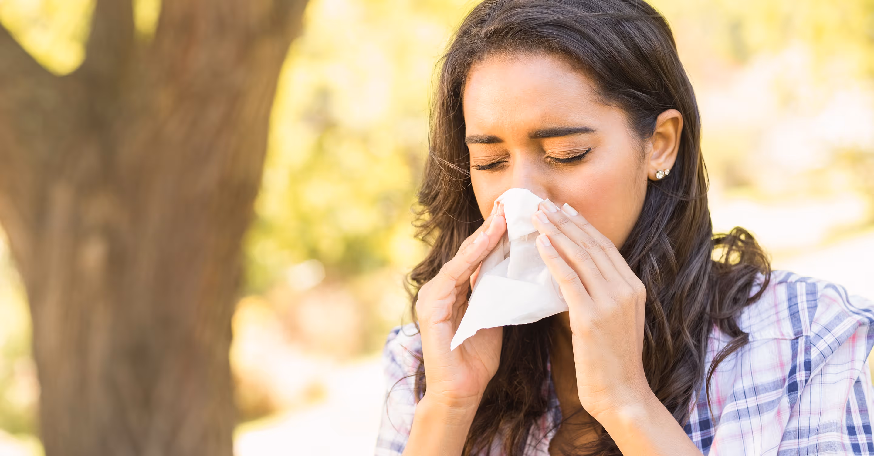 Woman outdoors with severe sinus problem