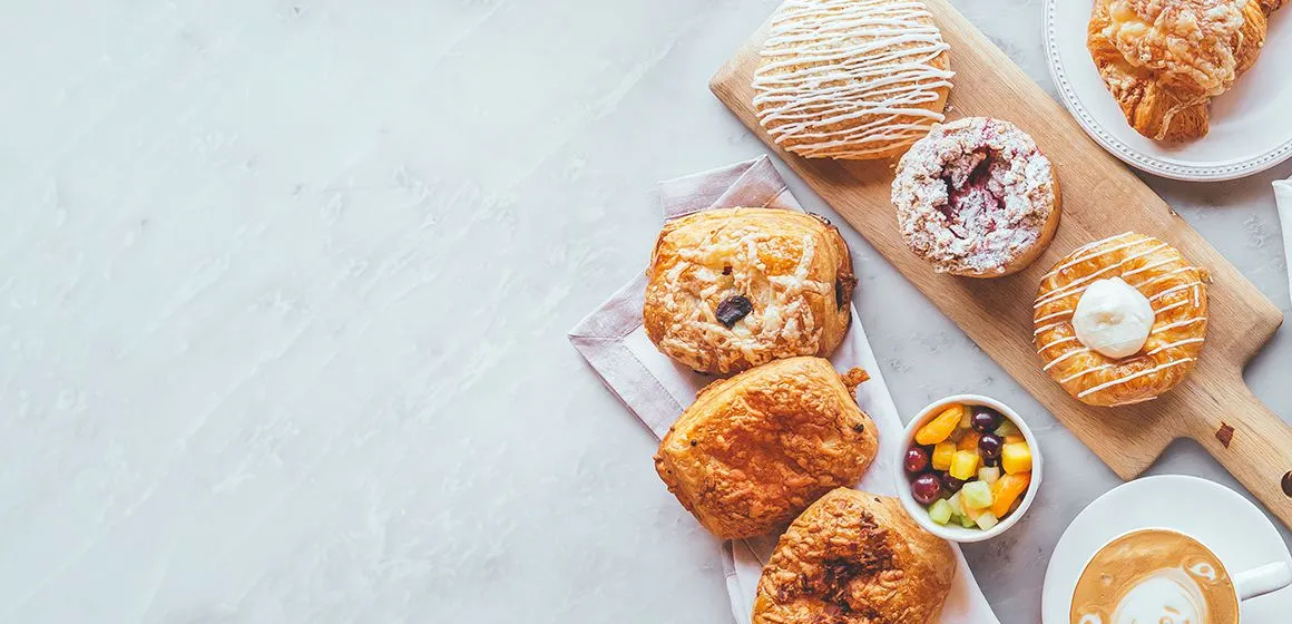 Assorted breakfast pastries, fruit and coffee