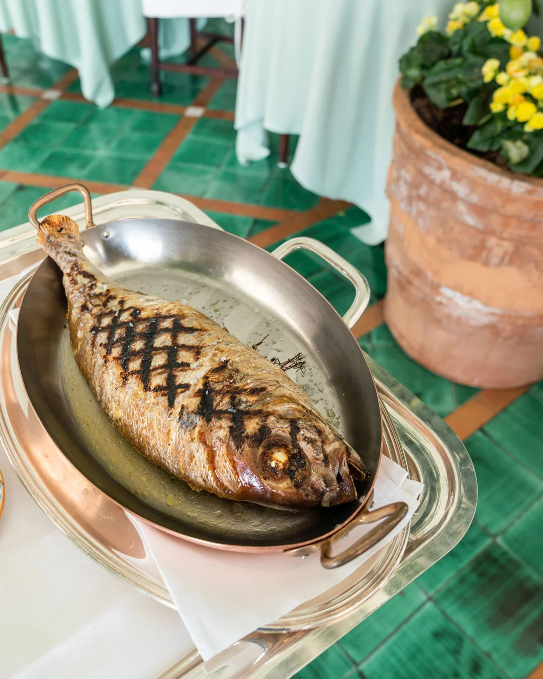 Grilled whole fish presented on a serving platter
