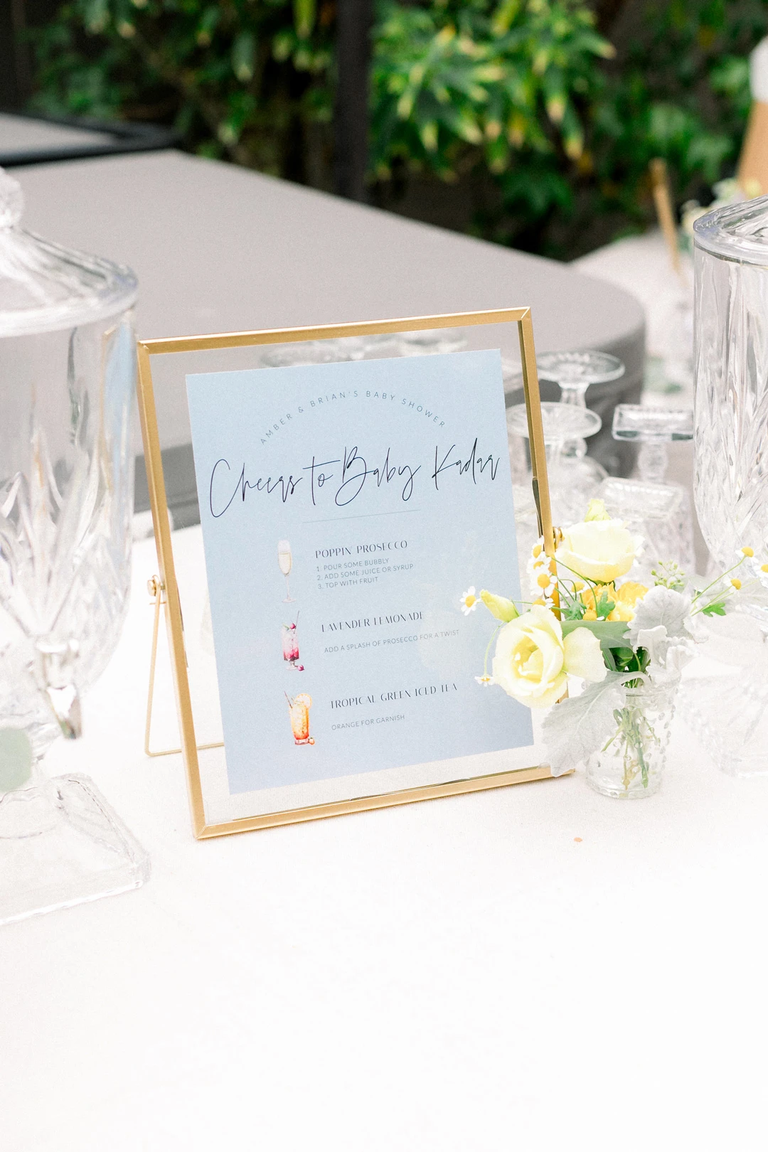 Framed beverage menu with a small yellow and blue floral arrangement