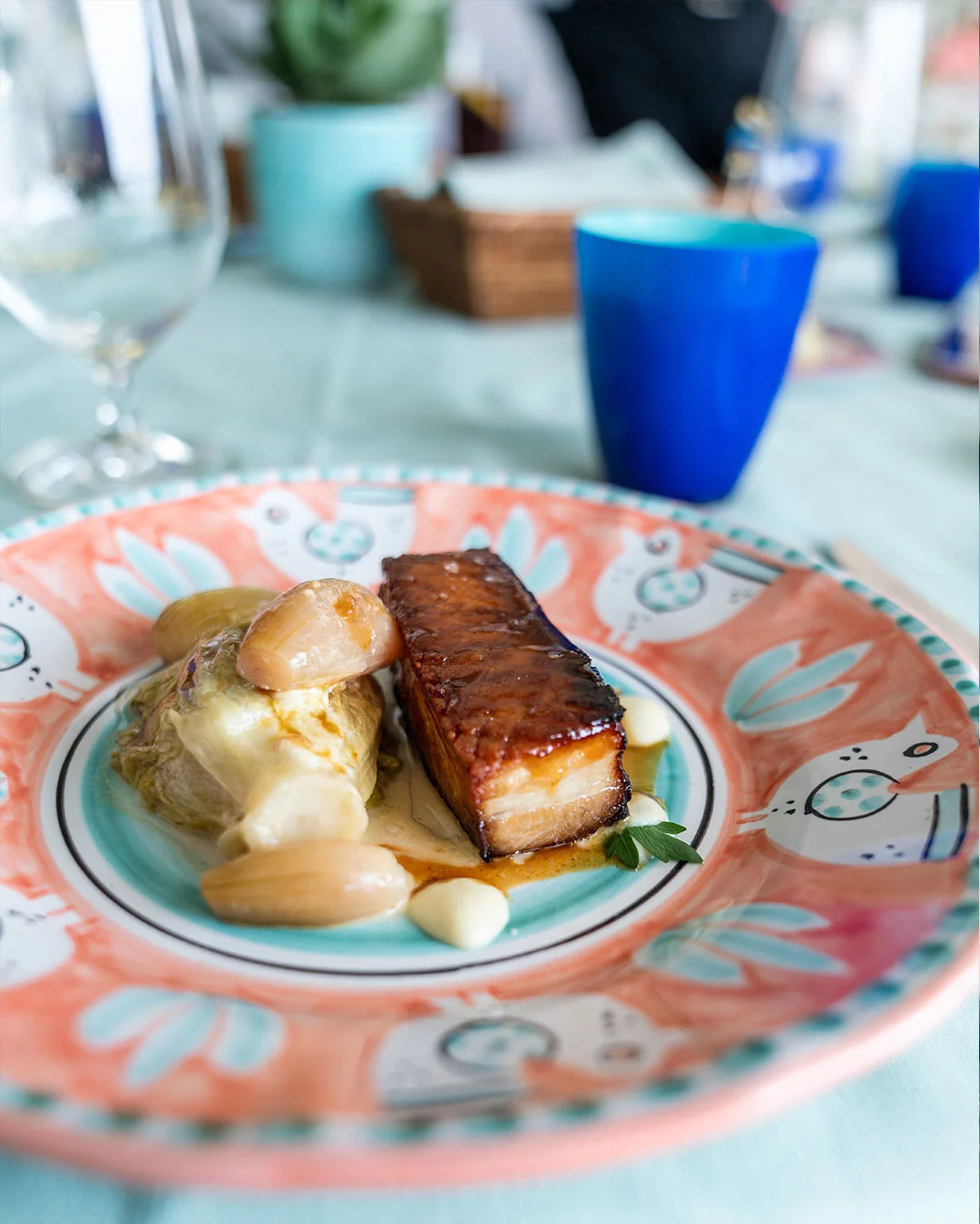 Two bite-size appetizers served on a patterned plate