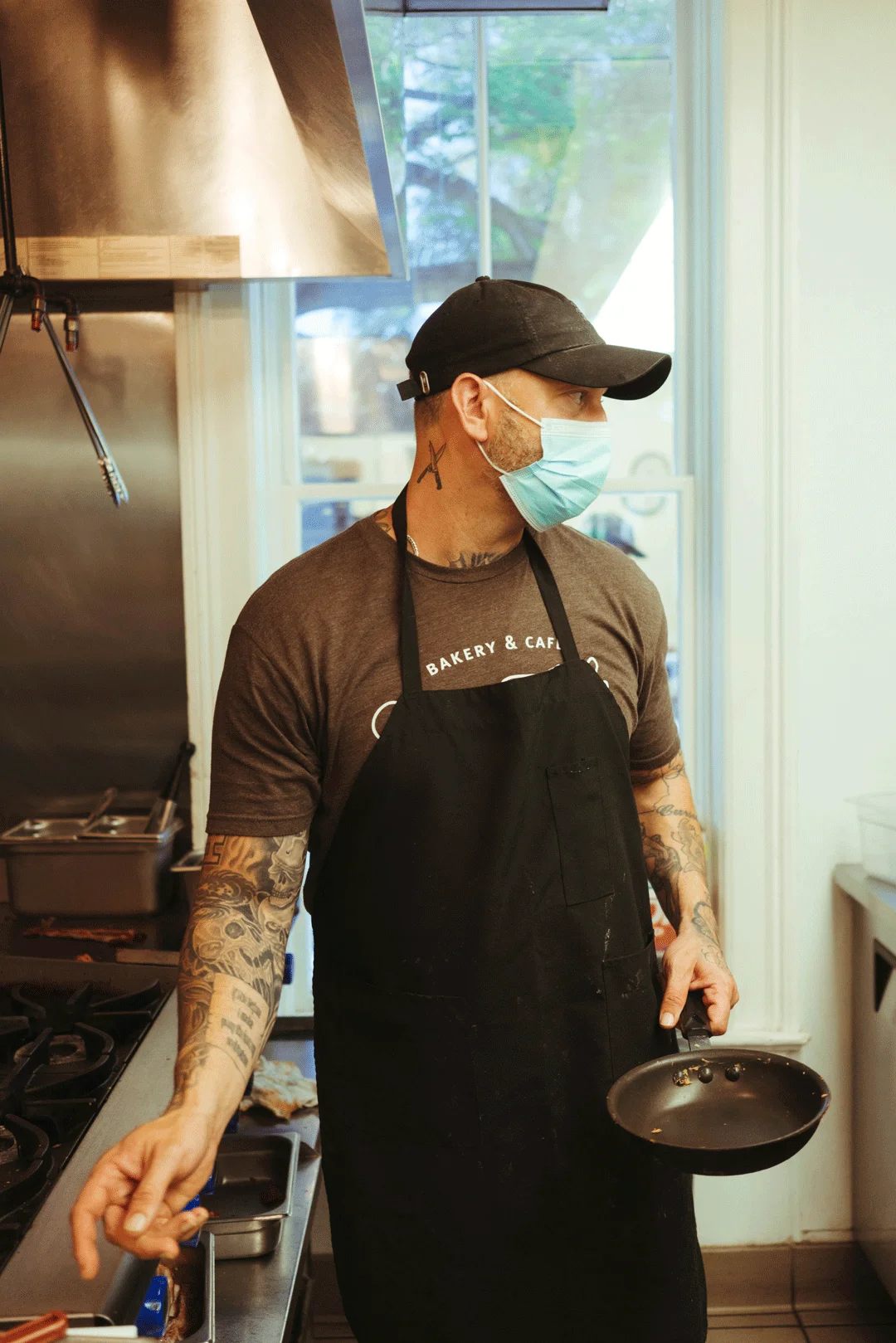 Chef Ken holding a skillet at the stovetop