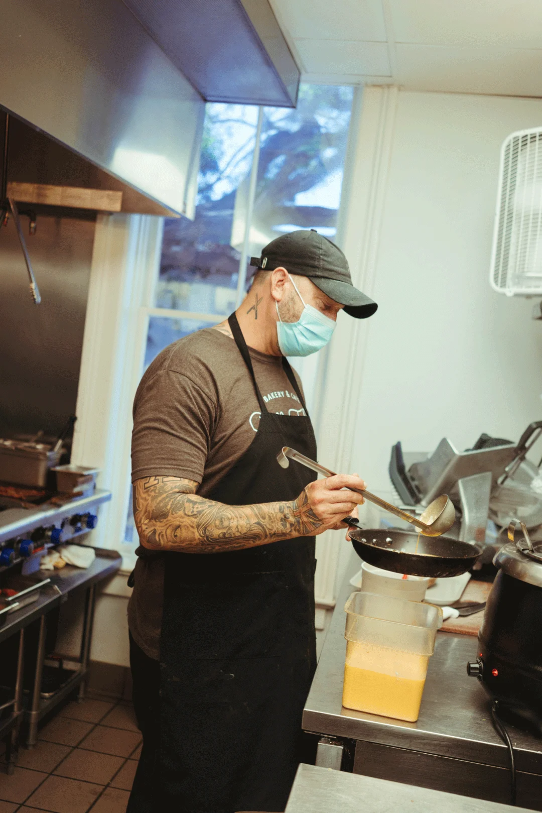 Chef Ken mixing ingredients in a kitchen container