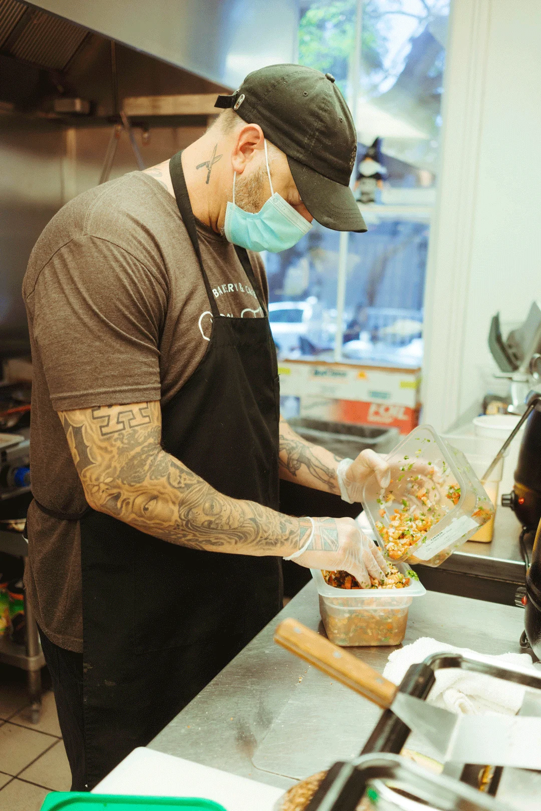 Chef Ken packing prepared food into a takeout container