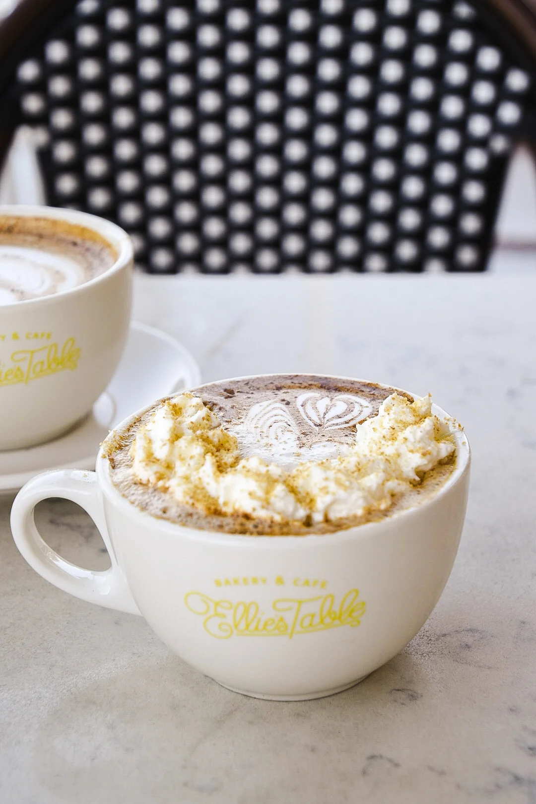 Pumpkin pie latte beside a dirty pumpkin chai