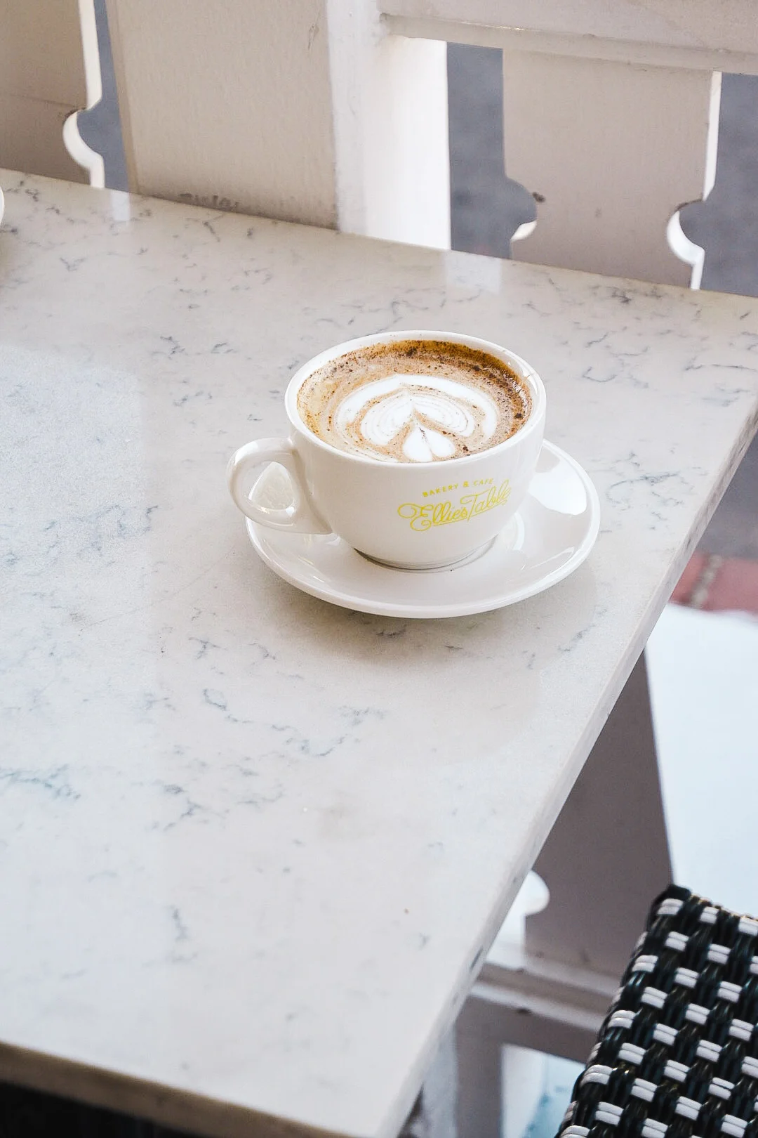 Dirty pumpkin chai in an Ellie’s Table mug on the café patio