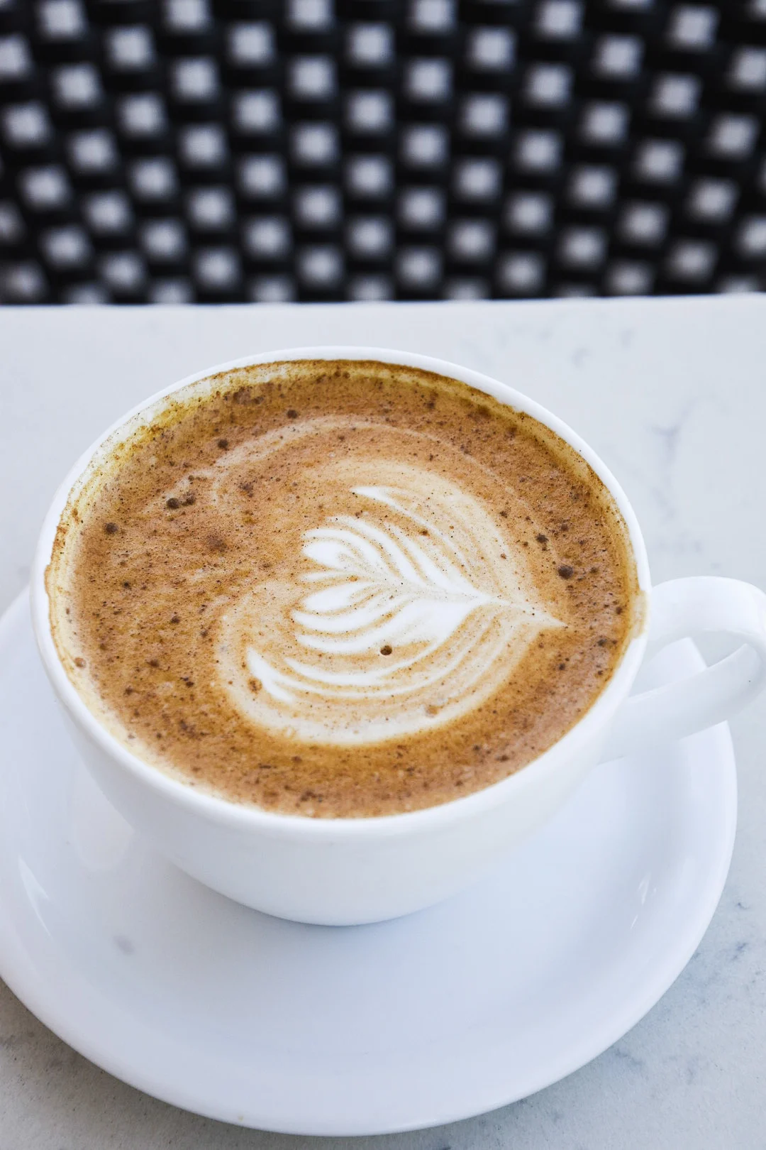 Churro latte topped with foam art and cinnamon